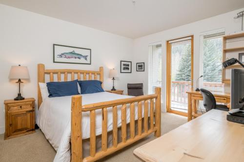 a bedroom with a bed and a desk and a tv at Snow Star - 1 in Ketchum