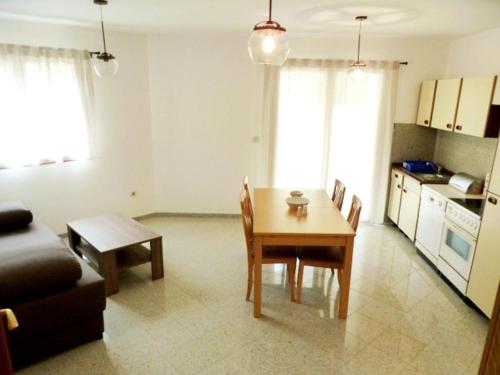 a living room with a table and a kitchen at Apartment Allegra in Banjole