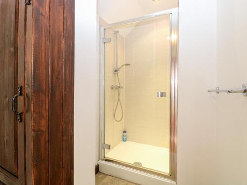 a shower with a glass door in a bathroom at Waterloo Retreat in Norwich