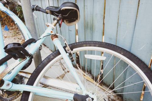 a bike is parked next to a fence at Serenity at Seascape: Steps to the beach & Shops in Palm Beach Shores