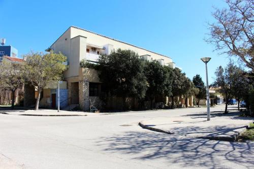 an empty street in front of a building at Josip 2 Gajac in Novalja