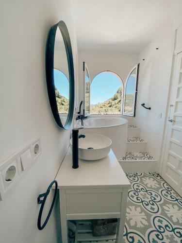 a white bathroom with a sink and a mirror at Montgo Home in Jávea