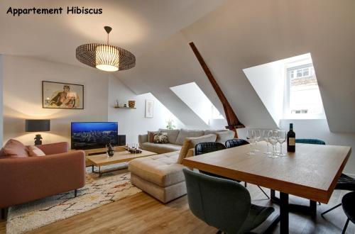 a living room with a couch and a table at Appartements de caractère centre in Vannes