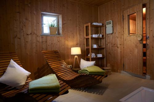 a room with two chairs and a lamp and a window at Schliersberg Alm in Schliersee