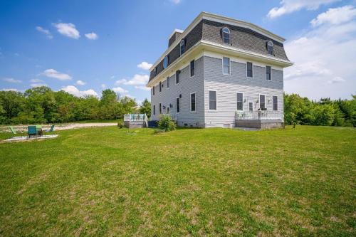 a large house on top of a grass field at The Starlight Tower Manor, River, Arcades, Observatory, Theater in Fort Atkinson