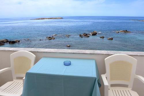a table and chairs on a boat in the water at Klinakis Beach Hotel in Chania Town