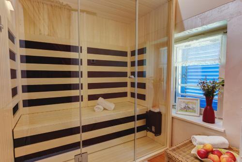 La salle de bains est pourvue d'une douche avec un banc et une fenêtre. dans l'établissement Casa Romantica, à Umag