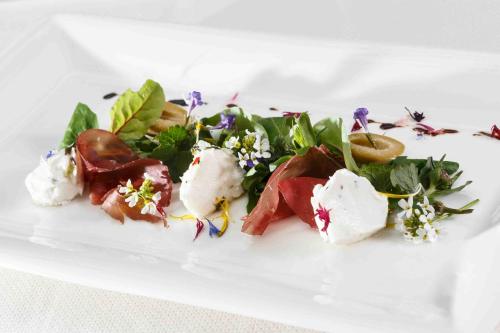 a white plate with some food on it at Naturhotel Rainer in Racines