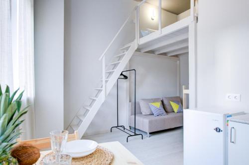 a living room with a loft bed and a couch at Двухуровневые апартаменты DOMIGO in Voronezh