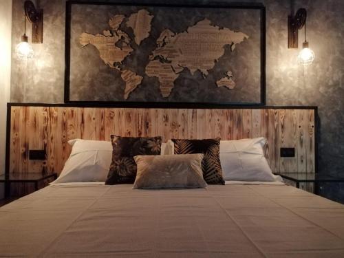 a bedroom with a large bed with a map on the wall at La Dimora del Principe-Piano terra in Trani