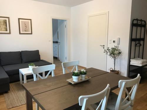 a living room with a wooden table and chairs at Ubytování U Potoka in Deštné v Orlických horách
