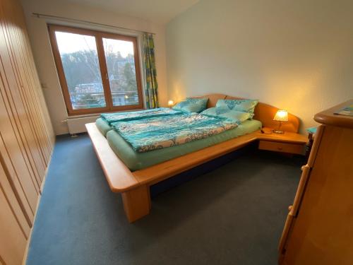 a small bedroom with a bed with a window at Tipp - Halle idyllisch am Fluss in Kröllwitz