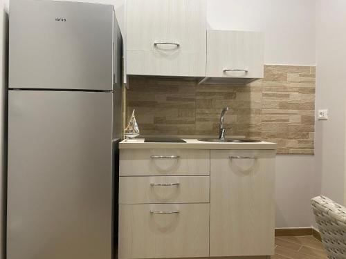 a kitchen with a refrigerator and a sink at Casa Vacanze Antares in Scilla