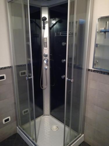 a shower with a glass enclosure in a bathroom at Monti di bò in Aggius