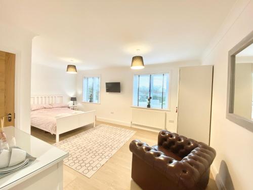 a bedroom with a bed and a chair in a room at Lottie's Lott in Stalybridge