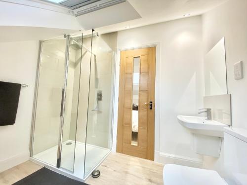 a bathroom with a shower and a sink at Lottie's Lott in Stalybridge