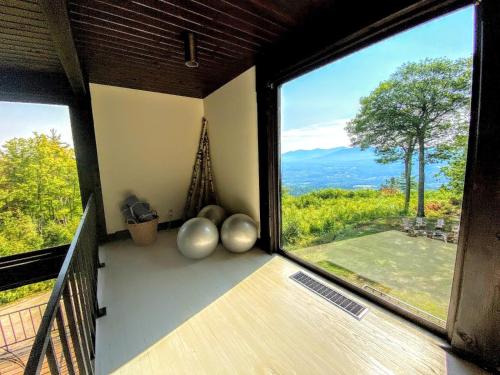a room with a large window with a view of a yard at RL Breathtaking views and grand unique style private mountain retreat 4WD recommended in Whitefield