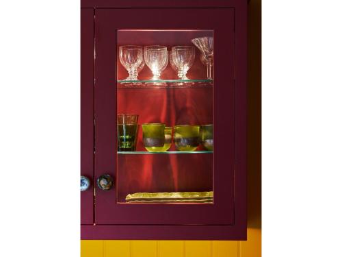 a purple cabinet with glasses on a shelf at Oppulent Lansdown Crescent Mews House with Free parking - Pass the Keys in Bath
