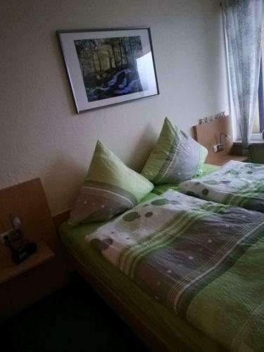 a bedroom with two beds and a picture on the wall at Gipfelzauber in Braunlage