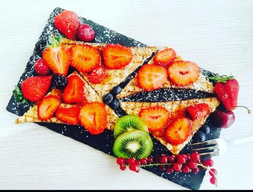 a plate of food with fruit on it at Il Nuraghe del lago Coghinas in Oschiri