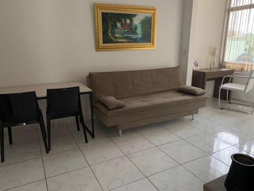 a living room with a couch and a table and chairs at Loft Central Master Collection in Passo Fundo