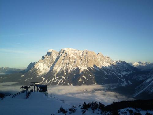 a mountain covered in snow with clouds in front of it at Appartements Schneezauber in Lermoos