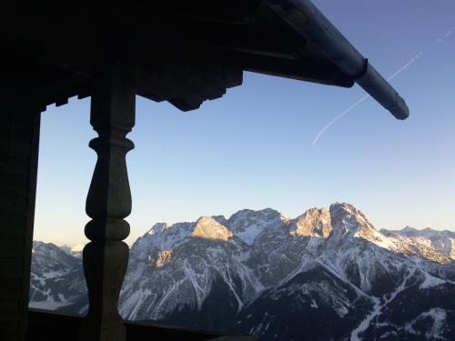 a view of a mountain range from a window at Appartements Schneezauber in Lermoos