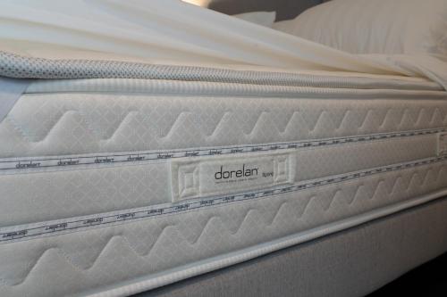 a close up of a white mattress on a bed at 4heavens_naples in Naples