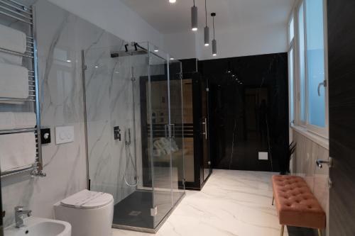 a bathroom with a shower and a toilet and a sink at 4heavens_naples in Naples