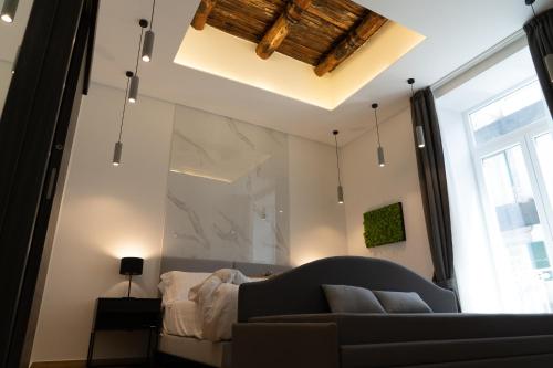 a living room with a couch and a large window at 4heavens_naples in Naples