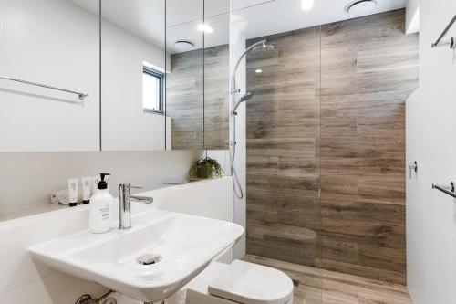 a bathroom with a sink and a toilet and a shower at Azure Apartments by Urban Rest in Sydney