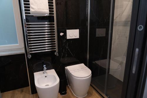 a bathroom with a toilet and a shower and a sink at 4heavens_naples in Naples