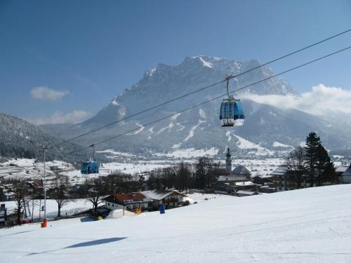 a ski lift in front of a snow covered mountain at Appartements Schneezauber in Lermoos