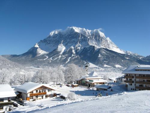 a ski resort with a mountain in the background at Appartements Schneezauber in Lermoos