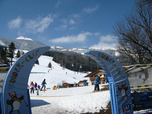 two flags in front of a ski slope with people at Appartements Schneezauber in Lermoos