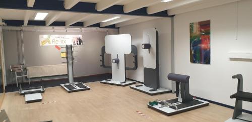 a room with a gym with exercise equipment in it at Sporthotel Papenburg in Papenburg