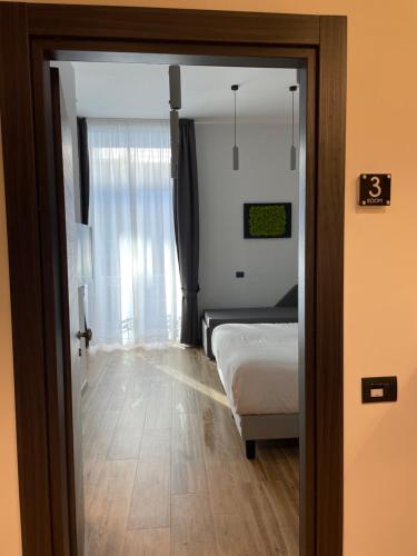 a bedroom with a bed and a window at 4heavens_naples in Naples