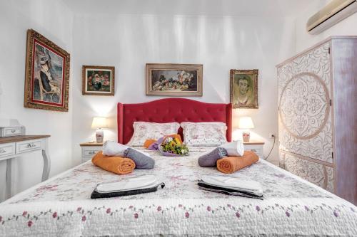 a bedroom with a large bed with pillows on it at Austella Suite in Corfu Town