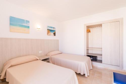 a hotel room with a bed and a desk at Apartamentos Avenida - MC Apartamentos Ibiza in Ibiza Town