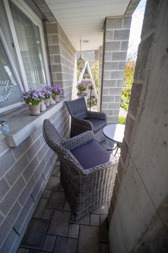 a patio with two chairs and a table and a window at Studio Living... in Langnau