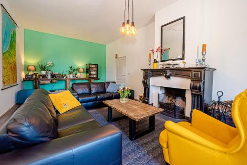 a living room with a couch and a fireplace at Bed & Breakfast Ohé en Laak in Ohé en Laak