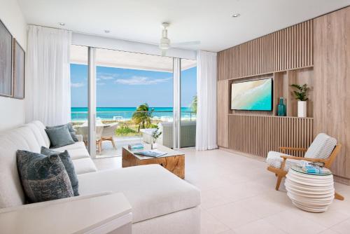 a living room with a view of the ocean at Wymara Resort & Villas in Grace Bay