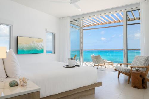 a living room with a view of the ocean at Wymara Resort & Villas in Grace Bay