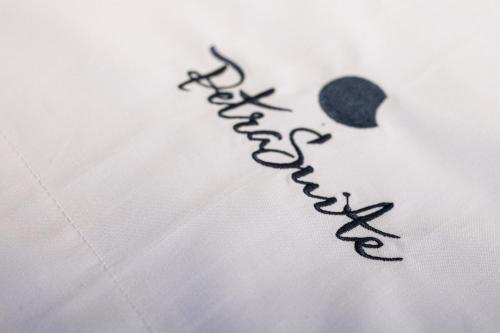 a writing on a white shirt with a heart at Petra Suite in Alberobello