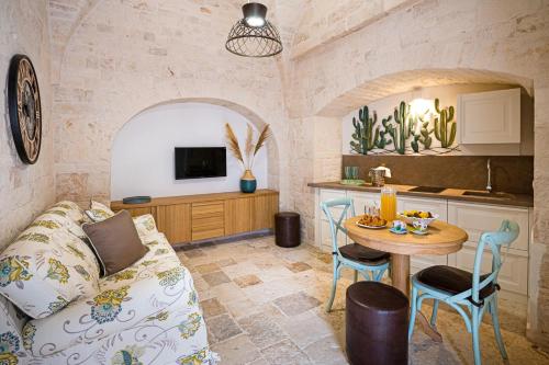 ein Wohnzimmer mit einem Sofa und einem Tisch in der Unterkunft Petra Suite in Alberobello
