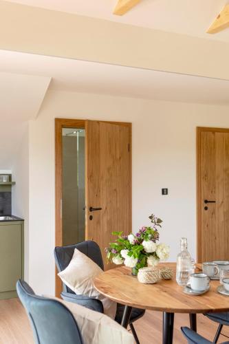 a dining room with a wooden table and chairs at Winzer Appartements Kogler in Leutschach