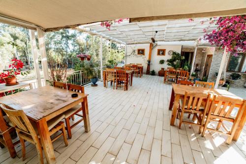 a patio with wooden tables and chairs on a patio at Eucalyptus Pension in Patara