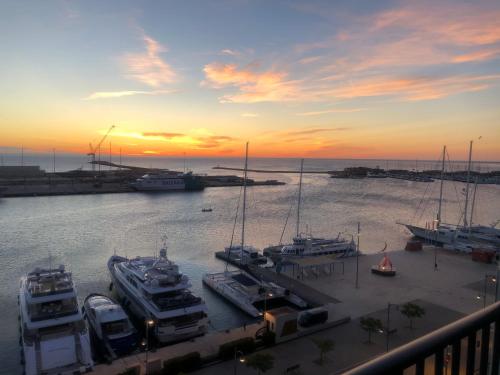 a group of boats docked in a marina at sunset at Harbour Views Puerto Denia II in Denia