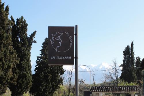 a sign on a pole in front of some trees at ReGenzio in Colledara
