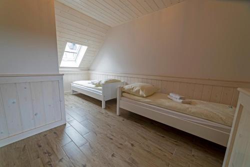 a room with two beds and a window at Willa Nad Wodospadem in Szczawnica